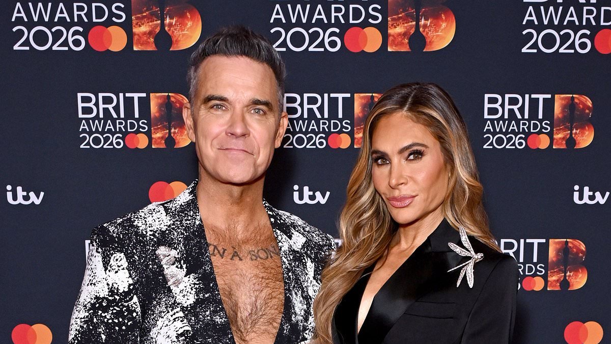 Robbie Williams cosies up to wife Ayda Field on the BRIT Awards red carpet ahead of his tribute performance to Ozzy Osbourne to close the ceremony
