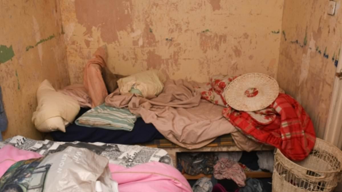 Sickening video reveals the filthy 'prison cell' room a vulnerable woman was kept in after being held as a slave by a scratch card addict for 25 YEARS - and the heartbreaking piece of paper police found hidden under her pillow