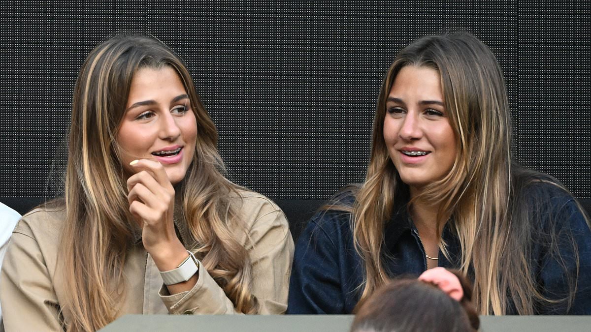 The rarely-seen twin sisters gripped by Australian Open tennis action - with a VERY famous dad! So can YOU guess who their legendary father is?