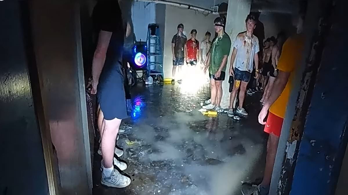 Moment police uncover 56 shirtless, blindfolded young men with food splattered on them in dark frat house basement