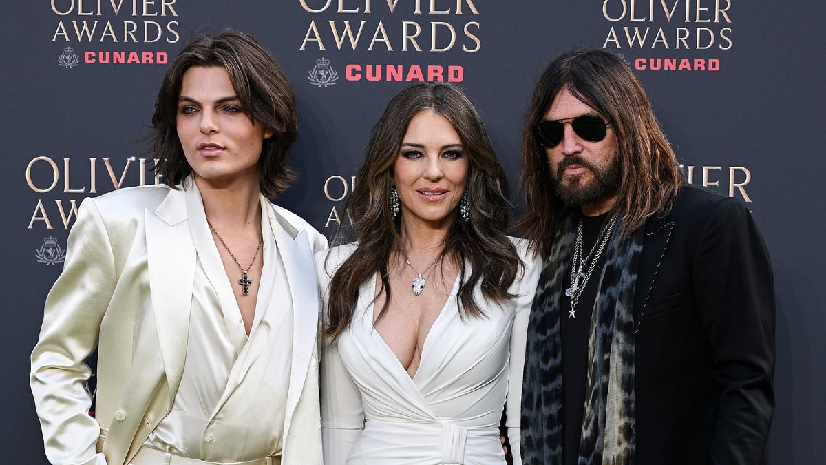 Elizabeth Hurley looks sensational in a plunging gown as she joins boyfriend Billy Ray Cyrus and son Damian at the star-studded Olivier Awards