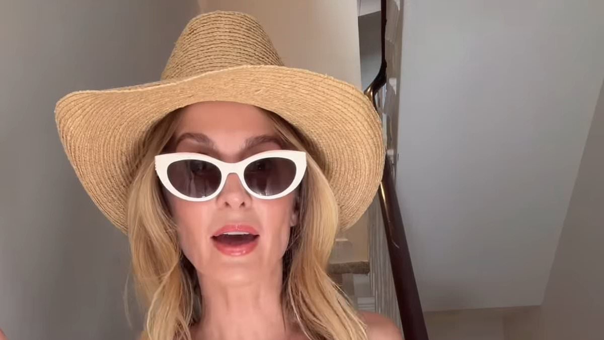 Newly single Millie Mackintosh shows off her toned figure in a white bikini as she pokes fun at the weather in hilarious clip