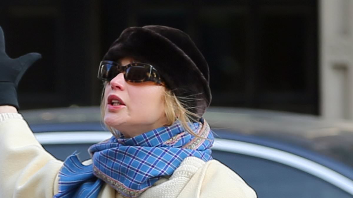 Exasperated Jennifer Lawrence throws her arms in the air after failing to hail a taxi in New York City