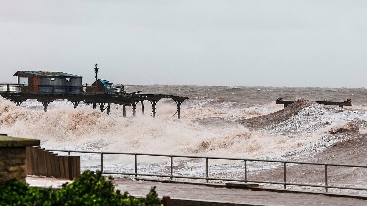 End of the pier show? Devon structure is battered by waves as nation hit by 150 flood alerts and warnings with yellow weather alert in place until Tuesday