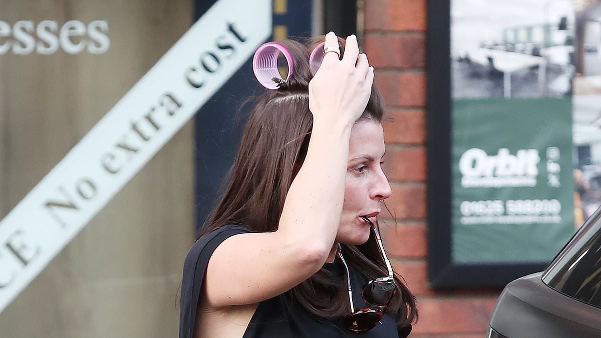Coleen Rooney sports pink rollers in her hair as she runs errands in Cheshire