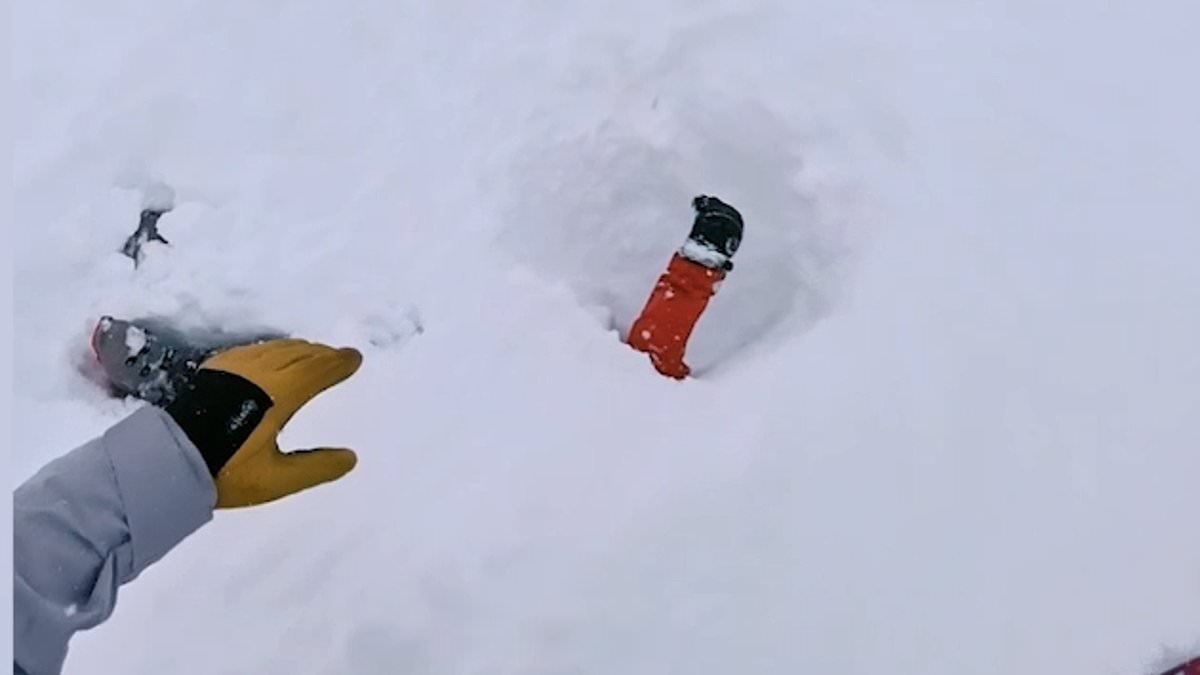 Amazing moment skier finds an arm sticking out of deep snow and frantically digs away snow to save victim after an avalanche in Switzerland