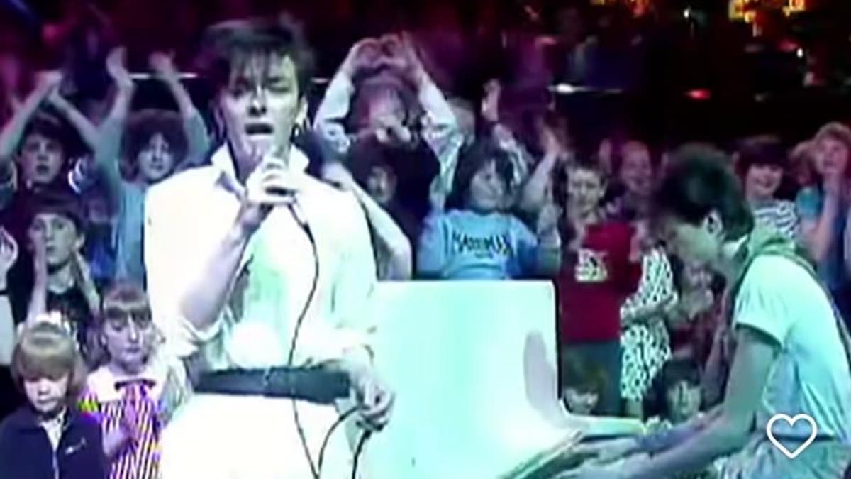 Ricky Gervais looks unrecognisable in belted white jumpsuit in 1983 photo taken when he was a pop singer