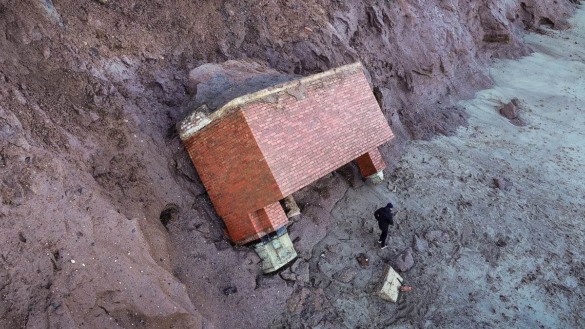 Cold War nuclear bunker topples off cliff and into the sea as it finally falls victim to erosion