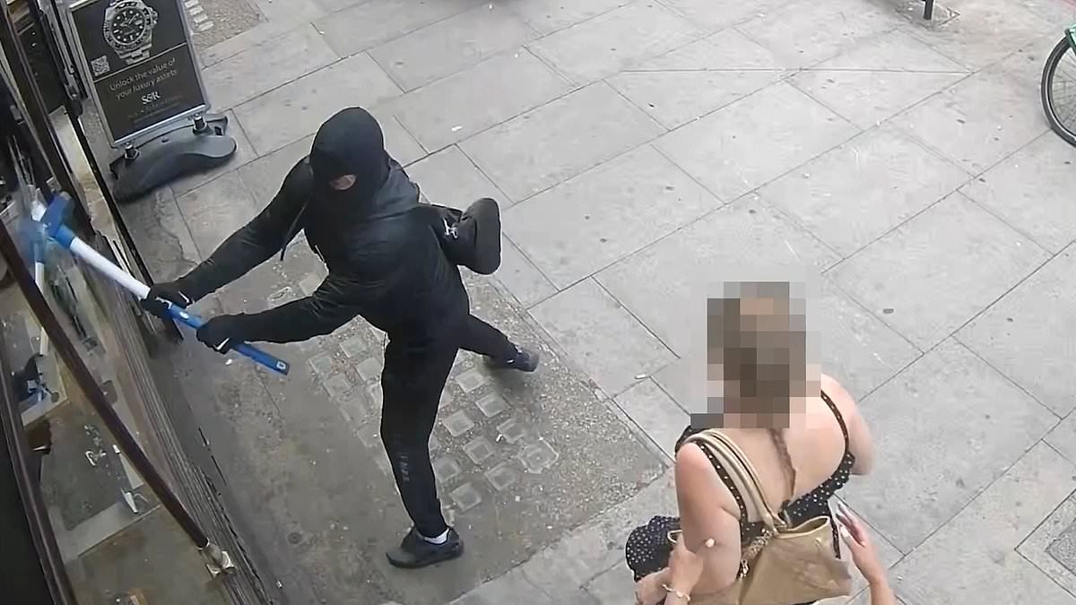 Moment sledgehammer-wielding thugs smash way into luxury store before fleeing with £60,000 of watches and jewellery