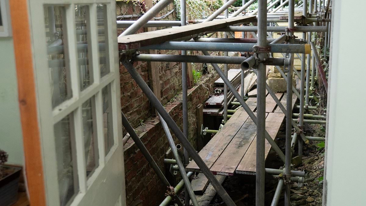 Council wipes £600,000 off the value of pensioner's £1million Cotswolds cottage after leaving scaffolding on it for seven YEARS