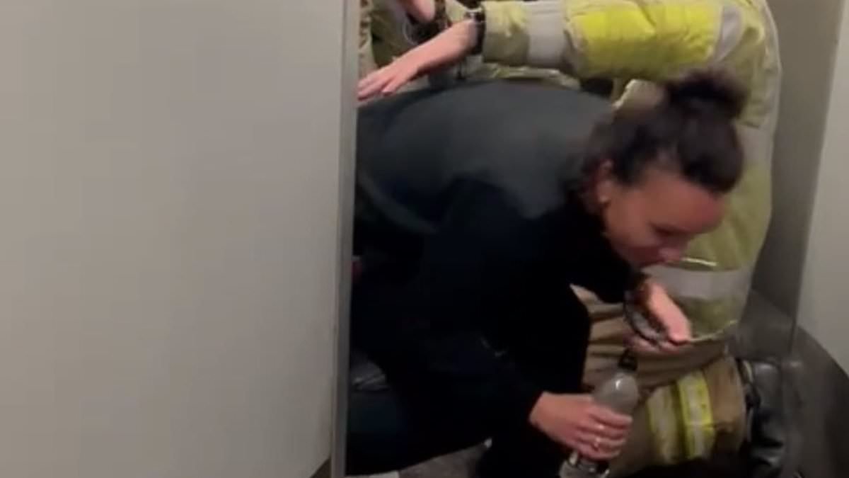 Moment passenger is cut out of train toilet after getting trapped for two hours when door malfunctioned and locked her in on the way to Hyrox event