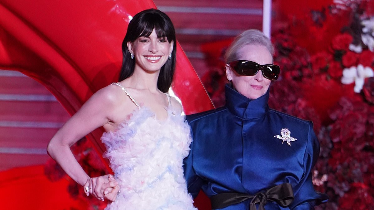 Anne Hathaway looks radiant in a sweeping feathered gown as she joins Meryl Streep at the Shanghai premiere of The Devil Wears Prada 2 - amid speculation about her youthful looks