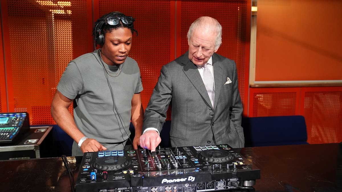 King of the decks! Charles tries his hand at DJing in Manchester - before agreeing 'it's not as easy as it looks'
