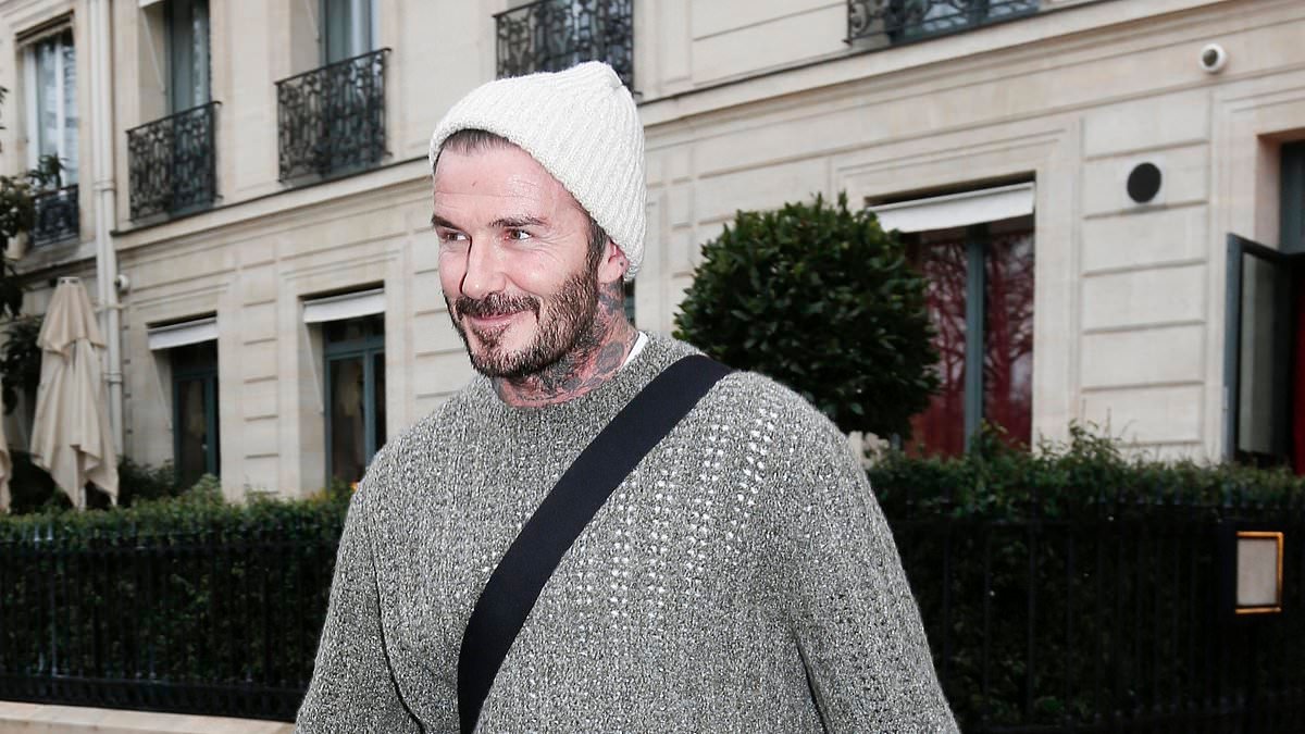 Handbags at dawn! David Beckham sports gargantuan Birkin and son Cruz mirrors his style with orange tote as they join Victoria and rest of family for day out in Paris amid Brooklyn feud