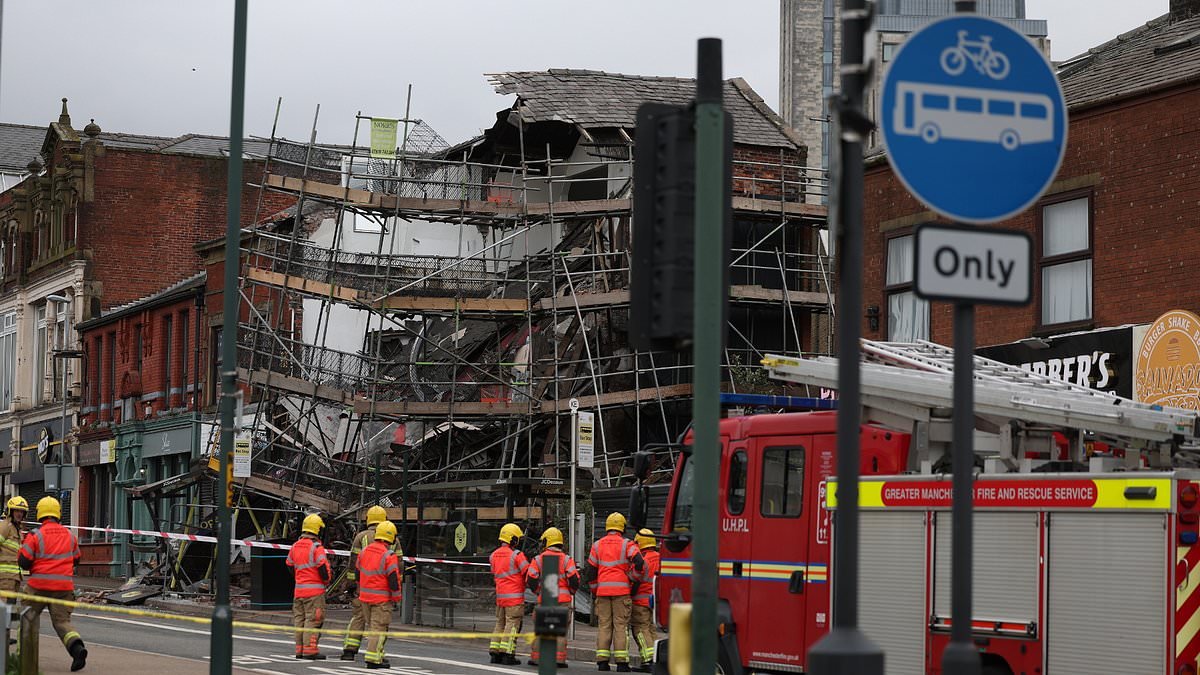 Three injured as building surrounded by scaffolding collapses in Greater Manchester street - as police urge people to stay away from scene