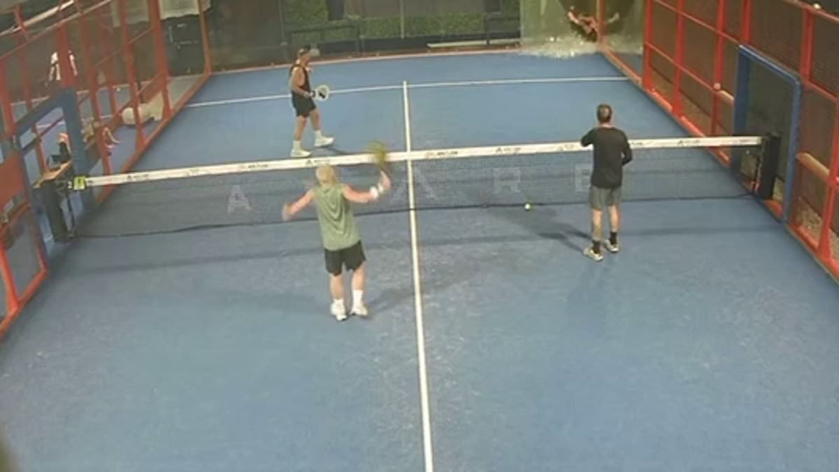 Terrifying moment an Aussie dad cheats death when a 3m-wall of glass explodes on top of him as plays game of padel ball in Bali