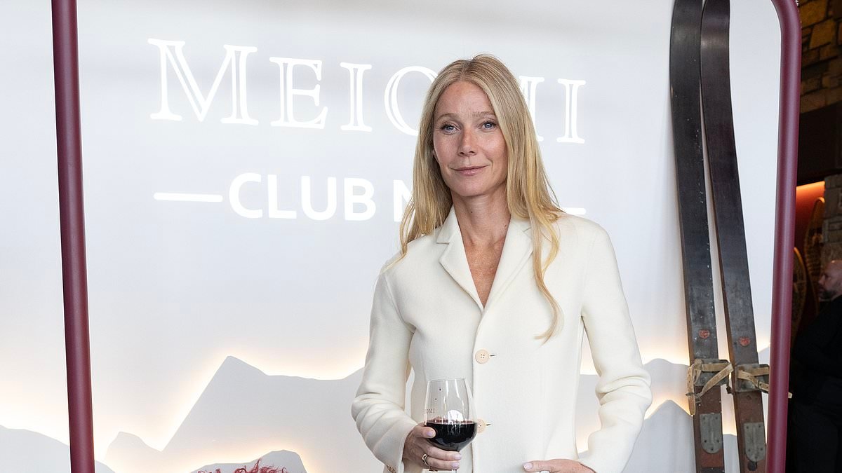 Gwyneth Paltrow looks chic in a  sweeping white frock coat and skirt as she raises a glass at boozy pop-up launch - after facing backlash for recommending a non-invasive cancer treatment