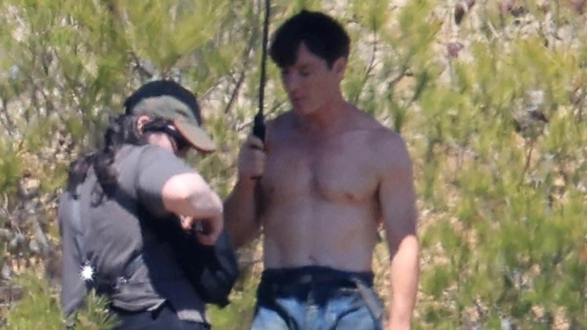 Shirtless Cillian Murphy, 49, shows off his sculpted abs as he shelters from the sun on the set of his upcoming prison drama with Daniel Craig