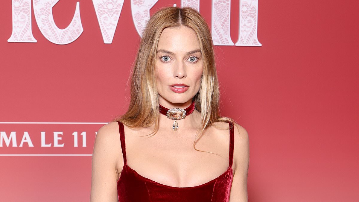 Margot Robbie gives a nod to the Georgian era in a red velvet Chanel gown with dramatic train at the Wuthering Heights premiere in Paris