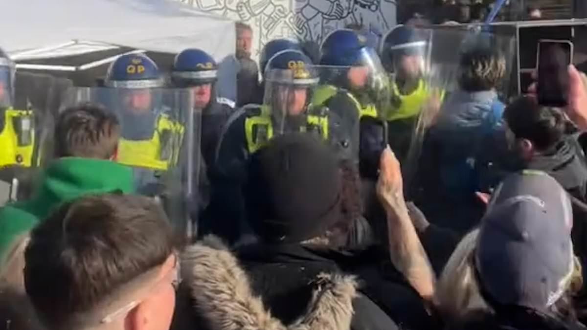 Riot police are pelted with missiles and an officer is attacked by revellers as they break up an all night illegal rave in rural village as 10 people are arrested