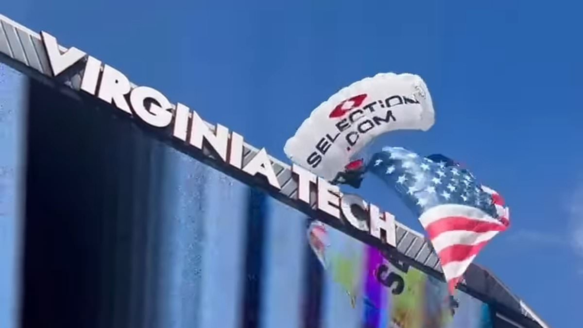 Horrifying moment skydiver is blown into scoreboard during festivities before college football game