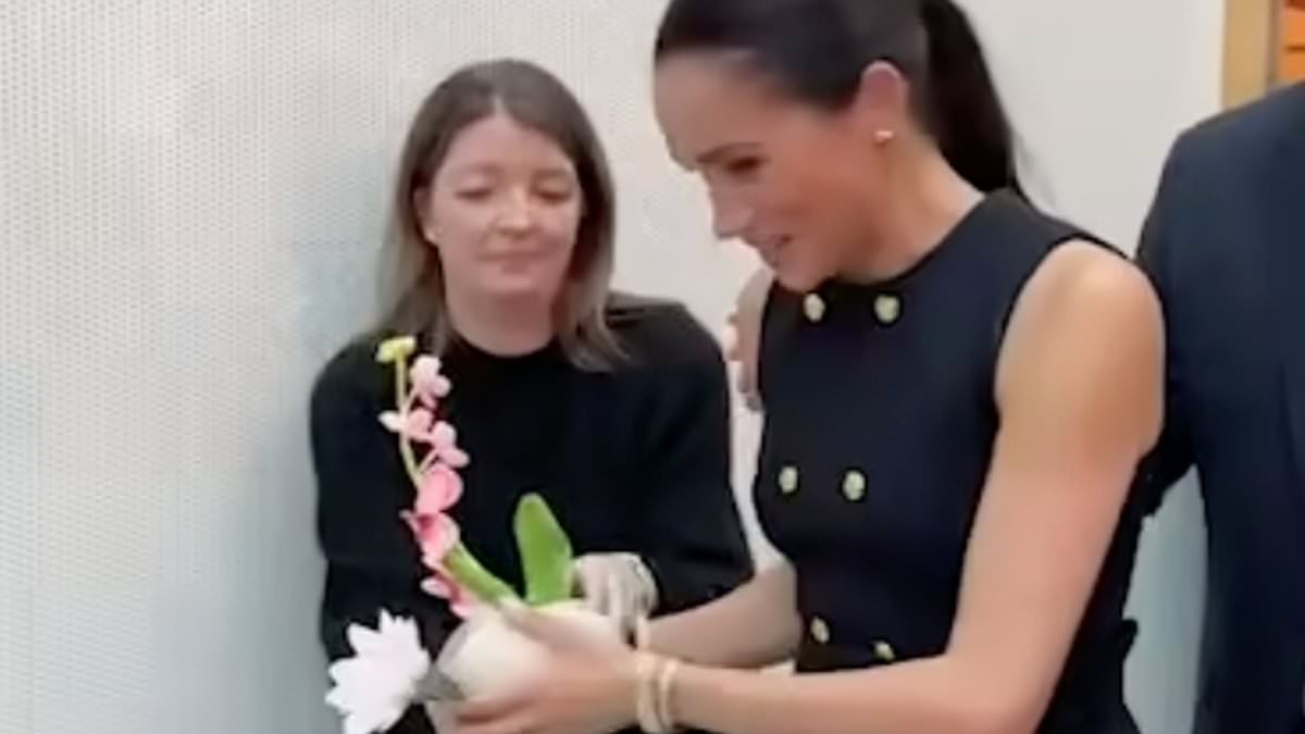 Just like a working royal! Moment Meghan hands gifted flowers to her aide during royal-style visit to children's hospital in Melbourne with Harry