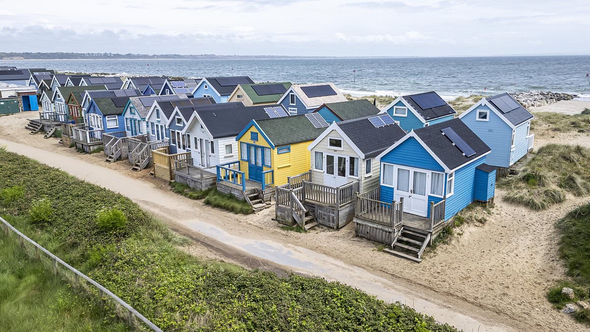 Beach hut owners claim they are being treated like 'wealthy NIMBYs' after being ordered to pay full council tax on 'second home' - but majority don't live in the area