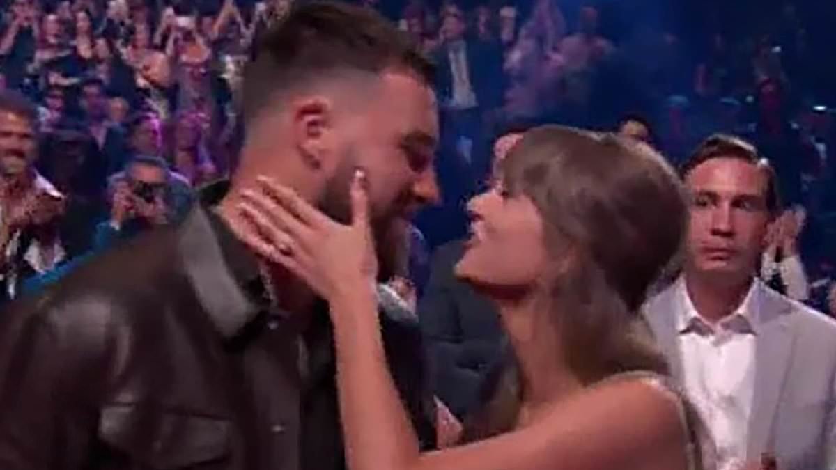 Taylor Swift sings 'Where Is My Husband?' to Travis Kelce as she flashes her engagement ring during Raye's iHeartRadio Music Awards performance