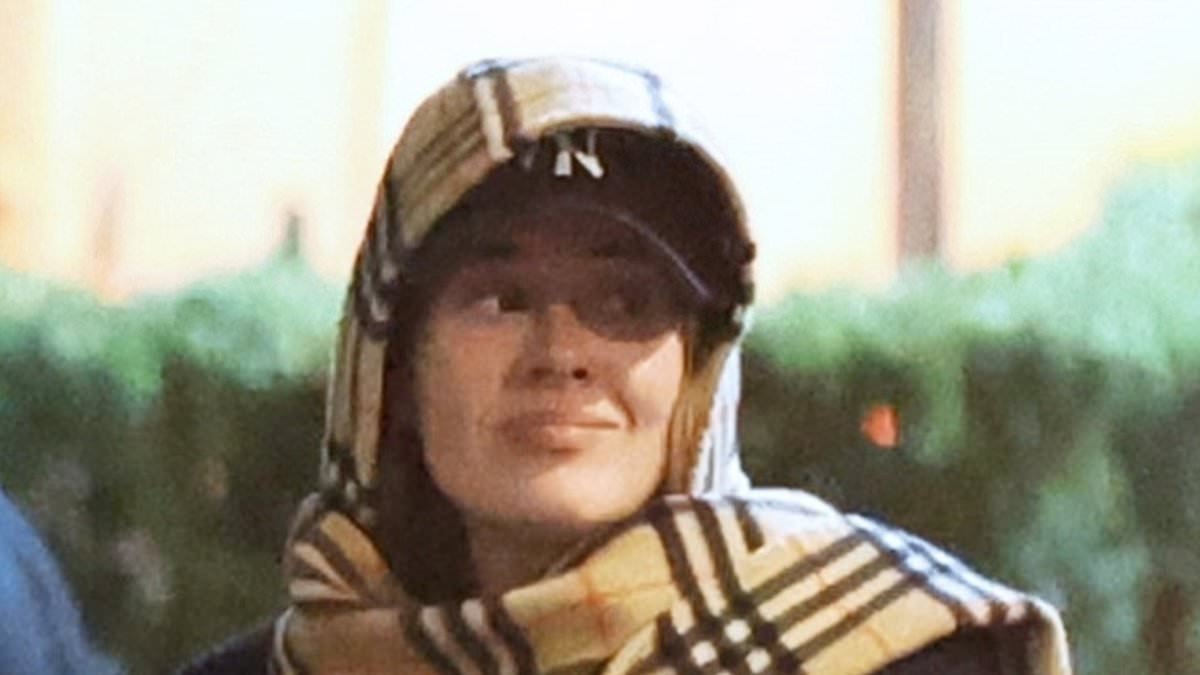 Adele cuts a low profile as she wraps up in a Burberry scarf and baseball cap while out and about in Rome