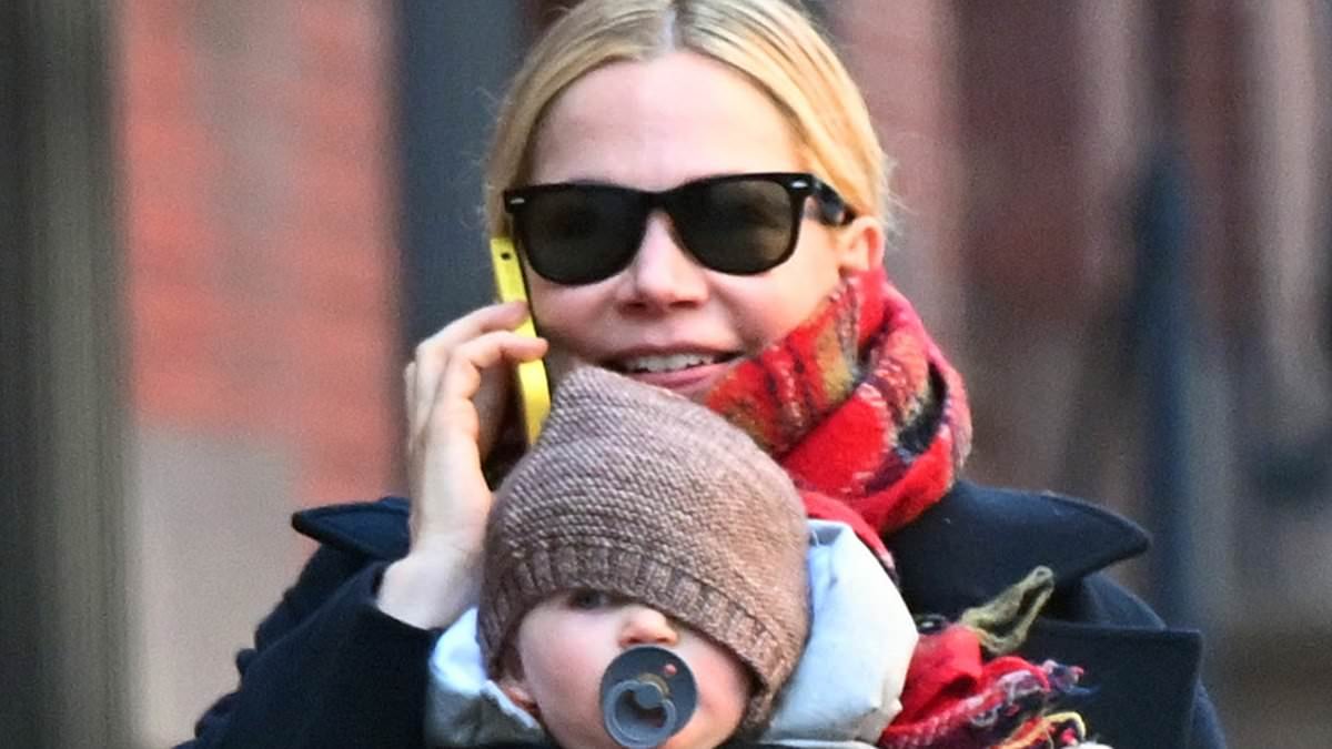 Michelle Williams, 45, is seen with her new baby for the first time -  five months after revealing she had quietly welcomed a fourth child via surrogate