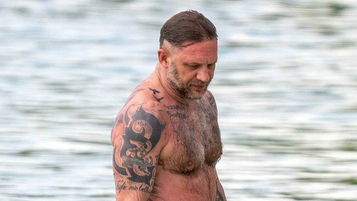 Shirtless Tom Hardy displays his vast collection of tattoos as he makes a rare appearance with bikini-clad wife Charlotte Riley on the beach in Barbados