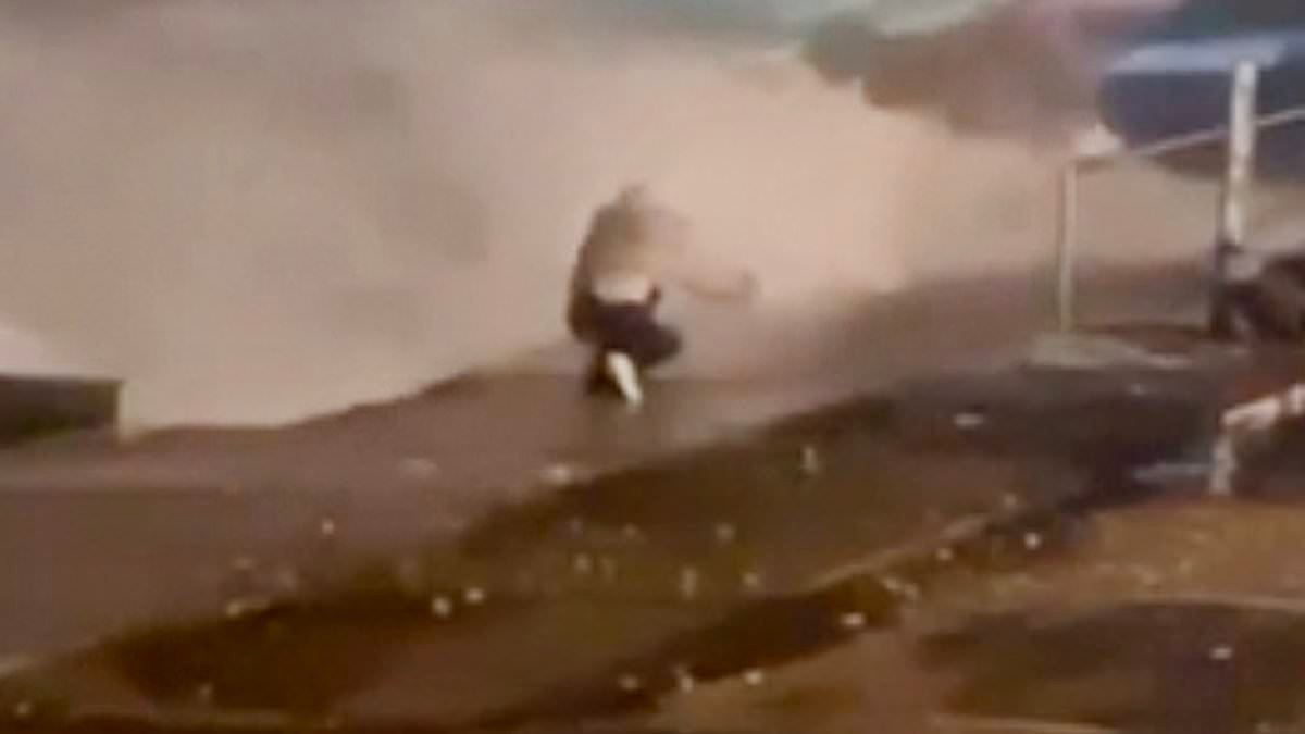 Moment teenage girl is nearly swept out to sea taking a SELFIE on a harbour wall during Storm Ingrid as weather washes away historic pier and batters coast