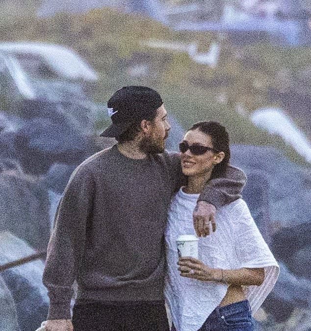 Brooklyn Beckham and his wife Nicola Peltz flash beaming smiles as they walk dog on Malibu beach in first sighting since issuing scathing statement about his estranged family