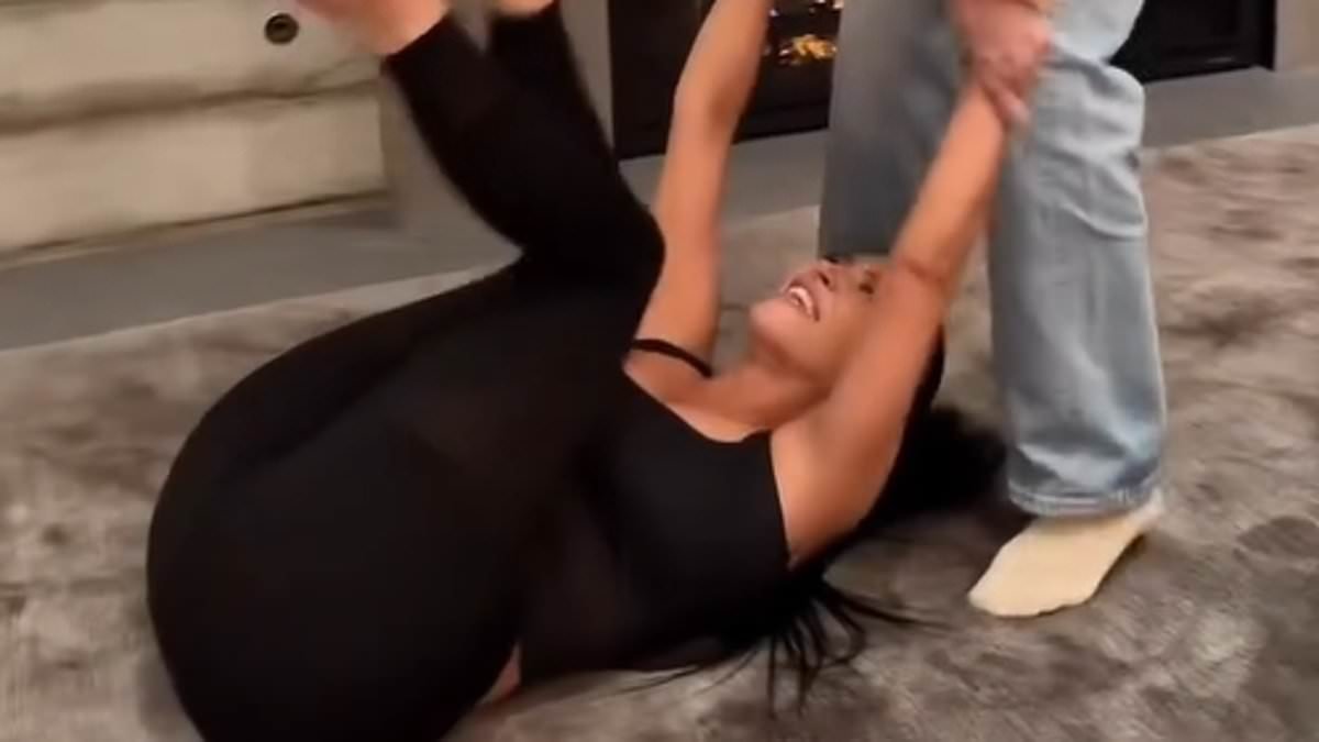 Lewis Hamilton proves he's part of the family as he cheers on Kim Kardashian's hilarious attempts at a viral couples challenge during night at home with her sisters