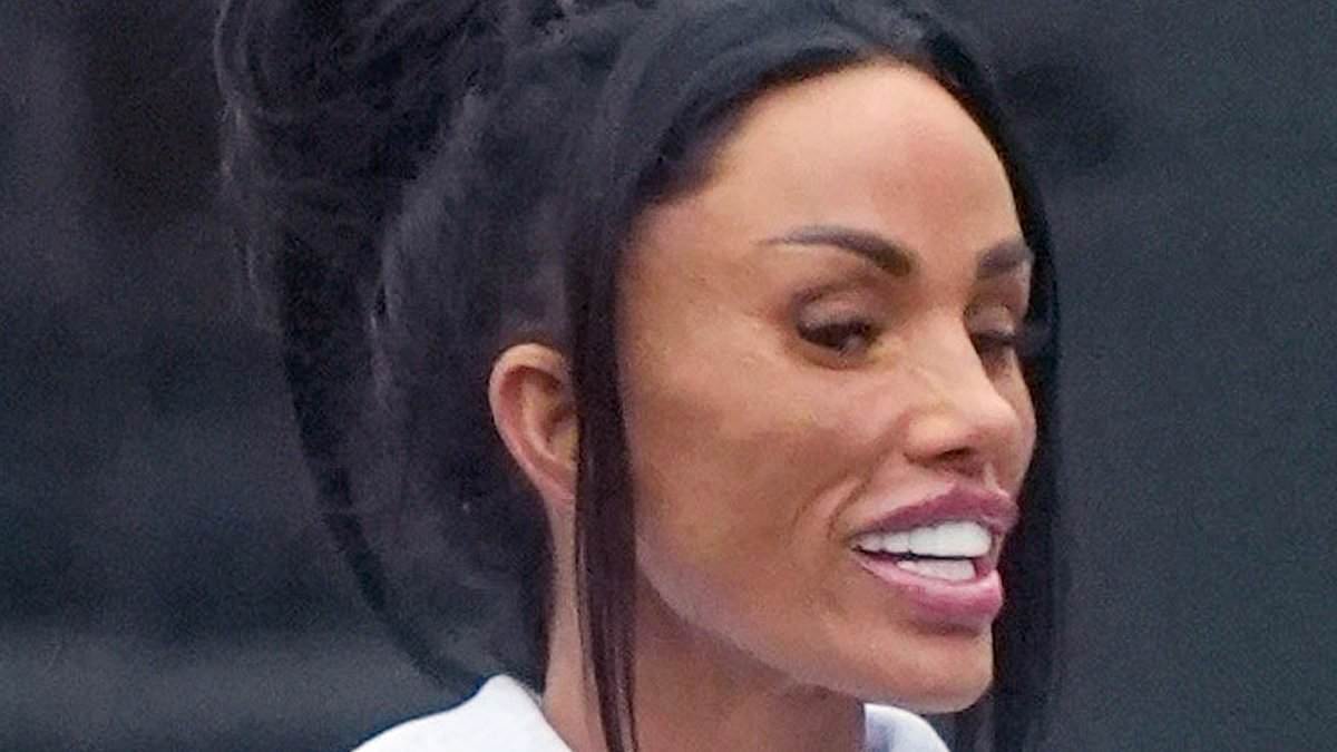 Katie Price shows off her 'kissable' new lips and covers up in a baggy tracksuit as she takes a swipe at ex JJ Slater by saying she wants a man with 'masculine energy'