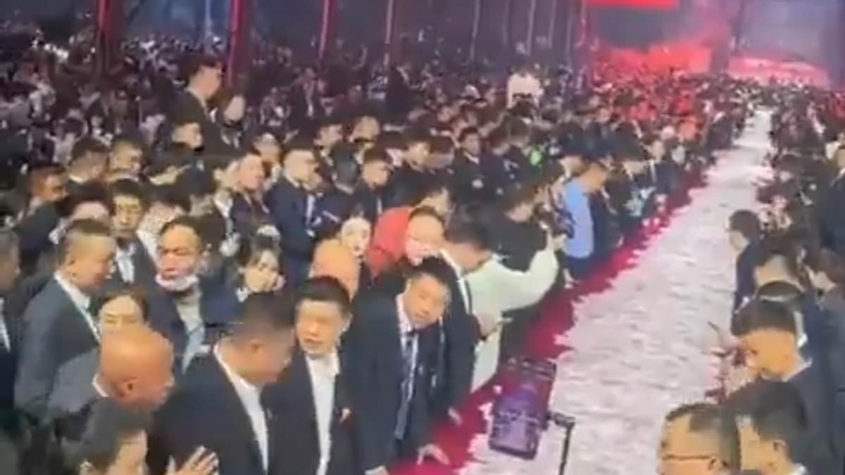 Thanks boss! Chinese company piles up $26million in bonus cash at end of year party with employees staggering off with as much as they can carry
